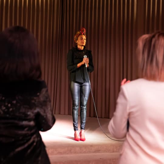 Woman speaker in front of a woman audience.