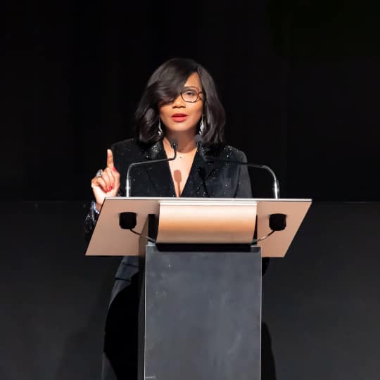 A black woman speaking at a podium.